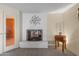 Charming living area with painted fireplace and neutral color palette at 7240 W Grovers Ave, Glendale, AZ 85308