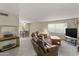 Comfortable living room featuring plush seating and view into the dining area at 7240 W Grovers Ave, Glendale, AZ 85308