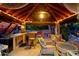 Cozy outdoor kitchen and seating area with wooden finishes and ambient lighting, perfect for al fresco dining at 7240 W Grovers Ave, Glendale, AZ 85308
