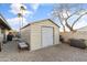 Durable metal storage shed for gardening tools and equipment, situated in the well-maintained backyard on a gravel area at 7240 W Grovers Ave, Glendale, AZ 85308