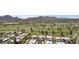 Scenic aerial shot of the community, golf course, lake, and mountain views at 7552 N San Manuel Rd, Scottsdale, AZ 85258