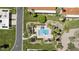 Aerial view of the community pool with lush landscaping, surrounded by homes and a nearby road at 7552 N San Manuel Rd, Scottsdale, AZ 85258