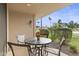 Cozy back patio with seating area and views of the green landscape with palm trees at 7552 N San Manuel Rd, Scottsdale, AZ 85258