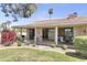 Spacious back patio with dining area, seating, and well-manicured lawn at 7552 N San Manuel Rd, Scottsdale, AZ 85258
