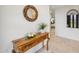 Inviting entryway featuring a wooden console table with decorative accents and a view into the bedroom at 7552 N San Manuel Rd, Scottsdale, AZ 85258