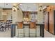 Open kitchen with granite countertops and bar seating, leading to the dining room at 7552 N San Manuel Rd, Scottsdale, AZ 85258