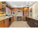 Spacious kitchen featuring custom wood cabinetry, tile floors, and stainless steel appliances at 7552 N San Manuel Rd, Scottsdale, AZ 85258
