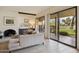 Cozy living room with neutral decor, fireplace, and sliding glass doors leading to the patio at 7552 N San Manuel Rd, Scottsdale, AZ 85258