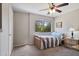 Bedroom featuring ceiling fan and window with view to trees and natural light at 811 W 13Th St, Tempe, AZ 85281