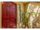 Inviting front door with decorative sidelight, lush potted plants creating a welcoming entrance at 811 W 13Th St, Tempe, AZ 85281