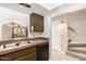 Functional kitchen featuring dual basin sink, black appliances, and open access to the living area through a serving hatch at 811 W 13Th St, Tempe, AZ 85281