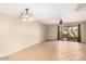 Open-concept living space with tile floors and a sliding glass door leading to a patio with natural light at 811 W 13Th St, Tempe, AZ 85281