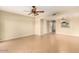 Spacious living room featuring neutral paint, tile flooring, ceiling fan, and pass-through to kitchen for easy entertaining at 811 W 13Th St, Tempe, AZ 85281