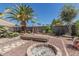 Relax in this rock landscaped backyard with a built-in firepit and a mature palm tree at 829 S Roanoke St, Gilbert, AZ 85296