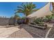 Enjoy a calm afternoon in the backyard that is covered with a large sun sail and gravel at 829 S Roanoke St, Gilbert, AZ 85296