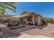 Backyard featuring a covered patio, gravel, a tiled walkway, and tropical plants at 829 S Roanoke St, Gilbert, AZ 85296