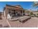 This backyard has a built-in fire pit with a covered patio and rock landscaping at 829 S Roanoke St, Gilbert, AZ 85296