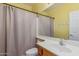 Bathroom featuring a sink, toilet, and shower with a gray curtain at 829 S Roanoke St, Gilbert, AZ 85296