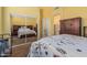 Bedroom with mirror sliding closet doors, dresser, and entry to another room at 829 S Roanoke St, Gilbert, AZ 85296