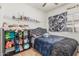 Cozy bedroom with a ceiling fan, shelving, and decorative tapestry at 829 S Roanoke St, Gilbert, AZ 85296