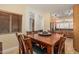 Warm dining room with an expansive wood table, seating for eight, and an open view into the kitchen at 829 S Roanoke St, Gilbert, AZ 85296