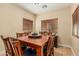 Dining room featuring a wooden table, seating for eight, neutral walls, and wood blinds at 829 S Roanoke St, Gilbert, AZ 85296