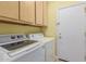 Laundry room with front load washer and dryer and overhead storage at 829 S Roanoke St, Gilbert, AZ 85296