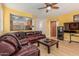 Spacious living room featuring a leather sofa, wood floors, and an open view to the kitchen area at 829 S Roanoke St, Gilbert, AZ 85296