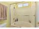 Bathroom shower and tub combination with glass doors and tile surround at 829 S Roanoke St, Gilbert, AZ 85296