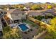 View of the house featuring a pool, lounge, and green turf at 8733 E Jacaranda St, Mesa, AZ 85207