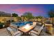 Enjoy outdoor living with a cozy fire pit, pool, and grill in this private backyard at 8733 E Jacaranda St, Mesa, AZ 85207