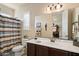 Well-lit bathroom featuring a single sink and view into the next room at 8733 E Jacaranda St, Mesa, AZ 85207