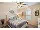 Cozy bedroom features a ceiling fan and shuttered window for gentle light at 8733 E Jacaranda St, Mesa, AZ 85207