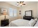 Bedroom with neutral colors, featuring a ceiling fan and shuttered windows at 8733 E Jacaranda St, Mesa, AZ 85207
