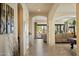 Spacious entryway with arched doorways and tiled flooring leading to the living room at 8733 E Jacaranda St, Mesa, AZ 85207