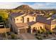 Beautiful two-story home with a well-manicured front yard and three-car garage at 8733 E Jacaranda St, Mesa, AZ 85207