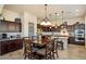 Elegant eat-in kitchen features a decorative chandelier and dark wood cabinetry at 8733 E Jacaranda St, Mesa, AZ 85207