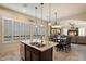 This kitchen island offers a sink and is conveniently located near the dining and living areas at 8733 E Jacaranda St, Mesa, AZ 85207