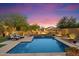 Relax in this beautiful pool surrounded by lush landscaping and a tranquil water feature at 8733 E Jacaranda St, Mesa, AZ 85207