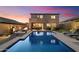 This home features a backyard oasis with a private pool, fire pit, grill, and putting green at 8733 E Jacaranda St, Mesa, AZ 85207