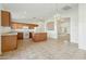 Eat-in kitchen features wood cabinets, white appliances, tile flooring, and decorative lighting at 89 S 151St Ave, Goodyear, AZ 85338