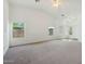 Bright and airy living room featuring neutral carpet, two windows, and a vaulted ceiling with a ceiling fan at 89 S 151St Ave, Goodyear, AZ 85338