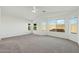Bright and airy main bedroom featuring neutral carpet, three windows, and a vaulted ceiling with a ceiling fan at 89 S 151St Ave, Goodyear, AZ 85338