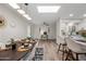 Stylish dining area with contemporary lighting, white chairs, and views of the bright and airy interiors at 9120 N 86Th Way, Scottsdale, AZ 85258