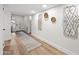 Hallway with light wood floors and neutral walls leading to various rooms in the home at 9120 N 86Th Way, Scottsdale, AZ 85258