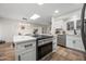 Well-lit kitchen with stainless appliances, white cabinetry, and a functional layout, complete with skylight at 9120 N 86Th Way, Scottsdale, AZ 85258