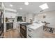Open-concept kitchen with stainless appliances, a wine fridge, and views of the living and dining areas at 9120 N 86Th Way, Scottsdale, AZ 85258