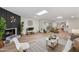 Open living room with a fireplace, hardwood floors and large windows with plantation shutters at 9120 N 86Th Way, Scottsdale, AZ 85258