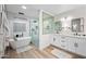 Bright and airy main bath features a soaking tub, glass enclosed shower, and dual vanity sinks at 9120 N 86Th Way, Scottsdale, AZ 85258