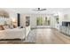 Bright main bedroom features light wood floors, ceiling fan, and french doors to outdoor living space at 9120 N 86Th Way, Scottsdale, AZ 85258